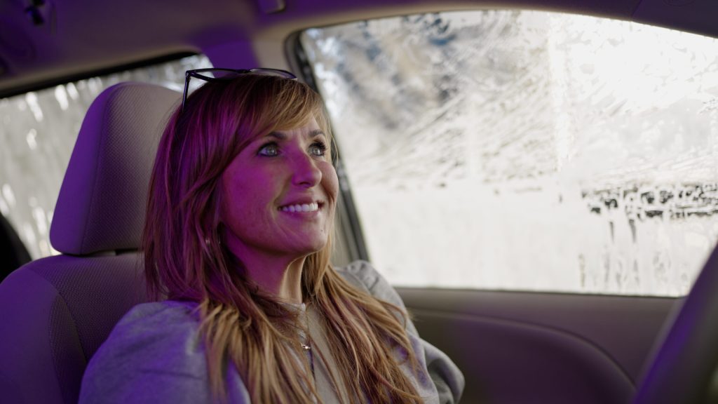 A Tidal Wave Auto Spa customer enjoys her car wash